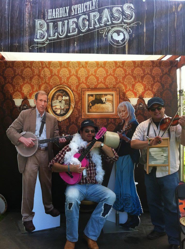 Steve with a pink guitar and feather boa at a bluegrass photo booth