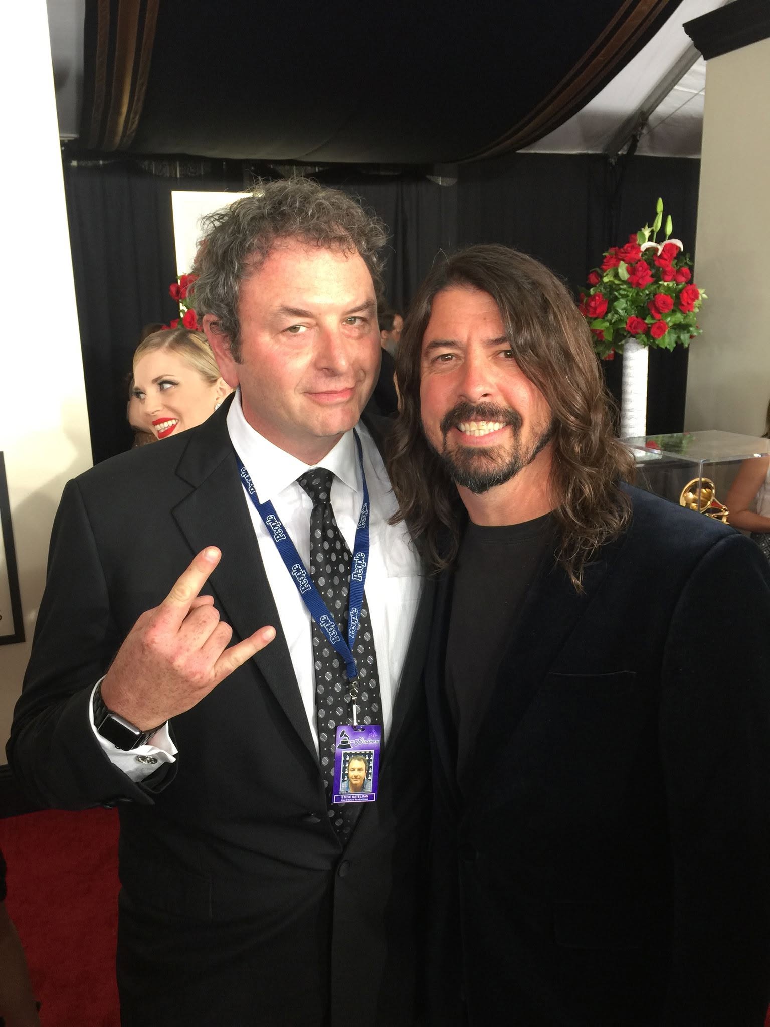 Steve making a rock hand gesture with a friend at an event